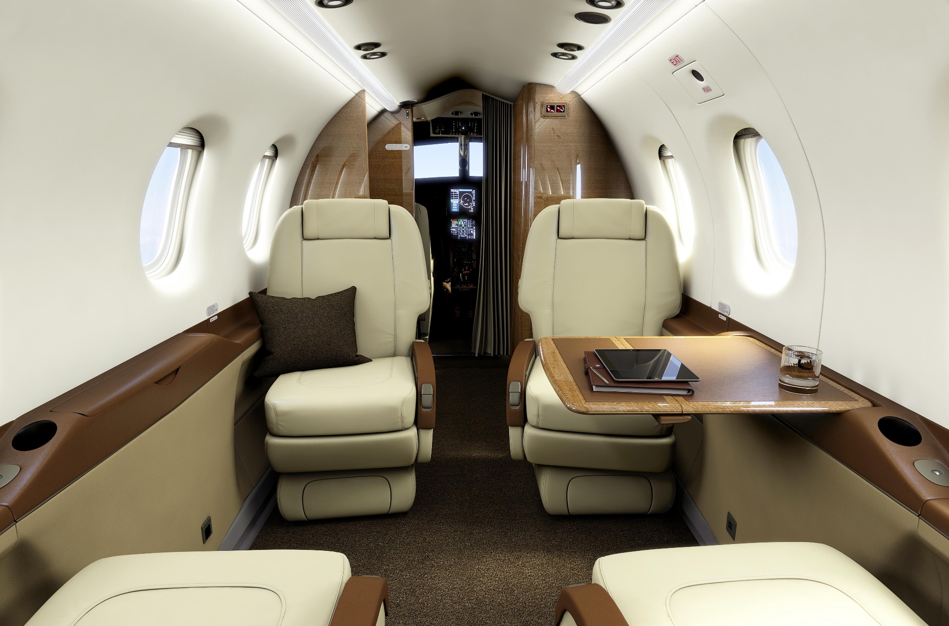 Pilatus PC-12 executive cabin with cream leather club seats and burl wood table